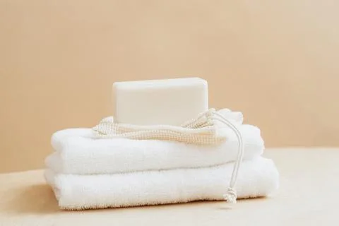 Bars of soap made from natural raw materials white soft towel beige background Stock Photos