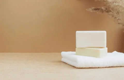 Bars of soap made from natural raw materials white soft towel beige background Stock Photos