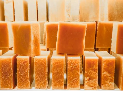 Bars of soap on a shop window. Orange soap with natural cedar oil and herbal Foto stock