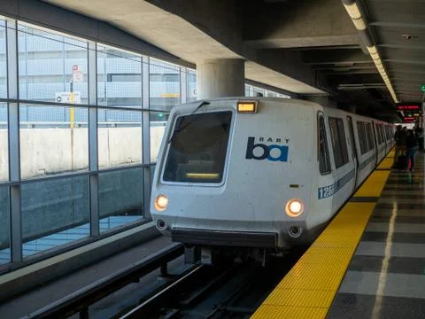 BART bay area rapid transit train pulling in at SFO airport stop Stock Photos