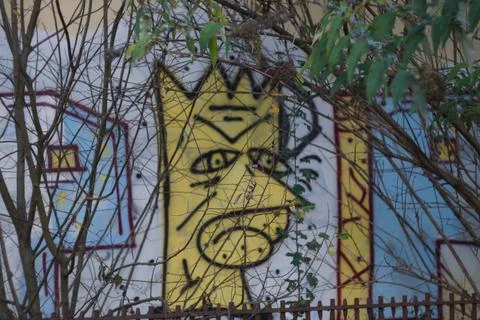 Bart Simpson graffiti with small trees covering it Stock Photos