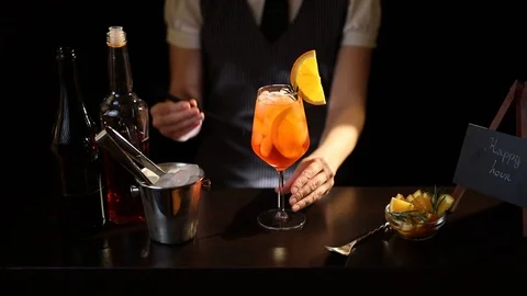 Bartender adding drinking straws into cocktail glass Stock Footage 126490942