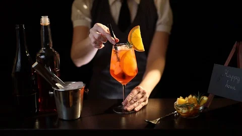 Bartender adding drinking straws into cocktail glass Stock Footage 128741380