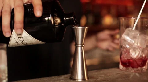 Bartender adding gin to cocktail Stock Footage 63297709