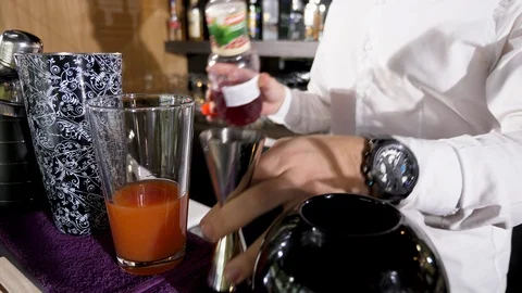 Bartender adding grenadine syrup to a drink Stock Footage 96018200