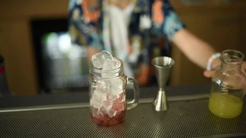 Bartender Adding Ice to a Cocktail at a Bar Stock Footage 278739668