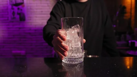 Bartender adding ice to cocktail glass Stock Footage 269559213