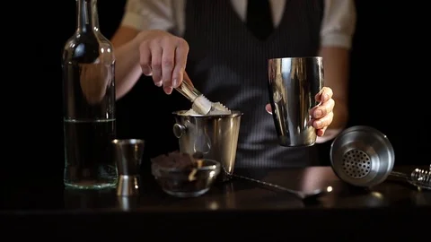 Bartender adding ice into cocktail shaker Stock Footage 124693235
