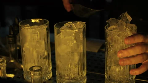 Bartender adding ice cubes to glasses Stock Footage 313798912