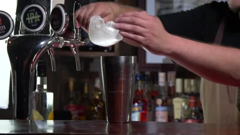 Bartender adding ice into metal shaker at a bar 4K 60fps Stock Footage 196821358