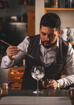 Bartender is adding ingredient in glass Stock Photos