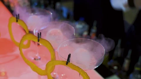 Bartender adding liquid nitrogen to orange cocktail at bar counter Stock Footage 314853926
