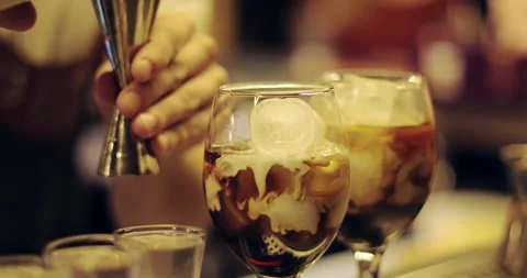 The bartender is adding milk to the cocktail. Stock Footage 140384993