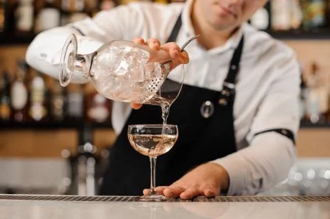 Bartender adding vodka into a cocktail glass Stock Photos