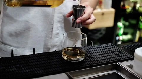 Bartender is adding whisky to the mixing glass,Slow motion. Stock Footage 63074808