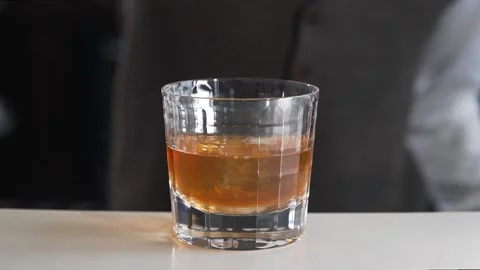 Bartender adds cherry to the alcohol drink at the bar Stock Footage 143587363