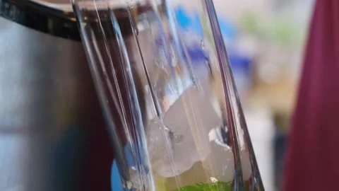 Bartender adds ice chunks glass lime slices making mojito alcoholic cocktail Stock Footage 159581953