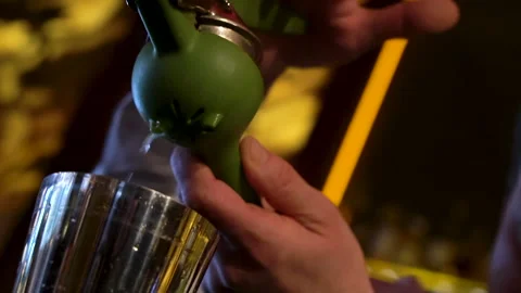 The bartender adds lemon juice to the cocktail shaker. Stock Footage 244940879
