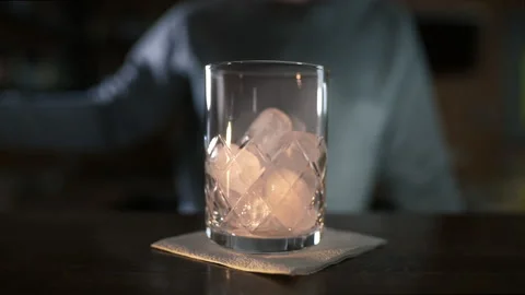 Bartender adds some ice to the glass before making cocktail Video stock 143587336