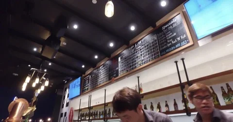 Bartender and diner enjoying drinks at cafe Stock Footage 74572727