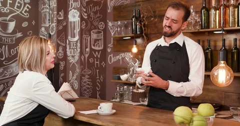 Bartender and waitress sharing stories after a wok day Stock Footage 104864414