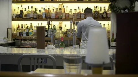 Bartender arranging glasses in a bar 動画素材 75209318
