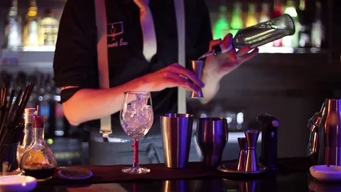 Bartender, barman is making delicious cocktail at bar counter using ice and swee Stock Footage 76472014