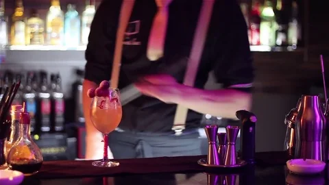 Bartender, barman is making delicious cocktail at bar counter using ice and swee Stock Footage 76472186