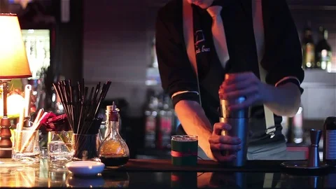 Bartender, barman is making delicious cocktail at bar counter using ice and swee Stock Footage 76472794