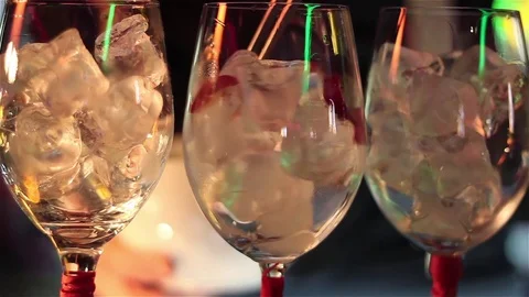Bartender, barman is making delicious cocktail at bar counter using ice and swee Stock Footage 76472870