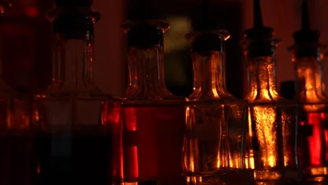 Bartender Bitters Bottles Backlit with Warm Light Stock Footage 318001748
