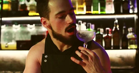 The bartender is blowing on a clean glass. Stock Footage 103387514