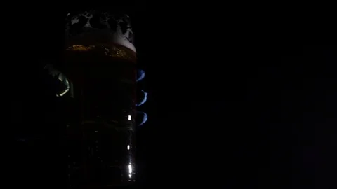 Bartender in blue gloves puts a pint of beer on the table Stock Footage 122851061