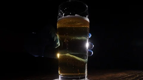 Bartender in blue gloves puts a pint of beer Stock Footage 122851236