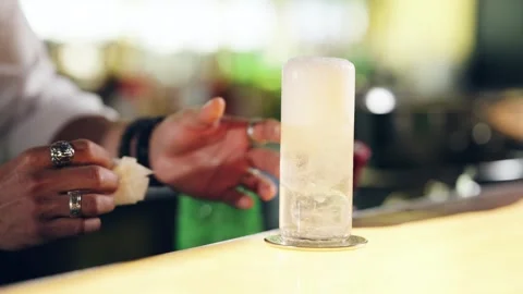 Bartender cleaning the bar counter after serving a cocktail Stock Footage 337885348