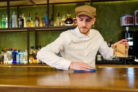 Bartender cleaning counter in a nice pub Stock Photos