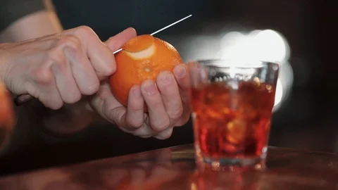 Bartender cleans orange for cocktail Stock Footage 129110941