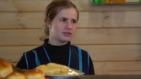 Bartender communicates with visitors to the restaurant. pies on the counter Video stock 123009264