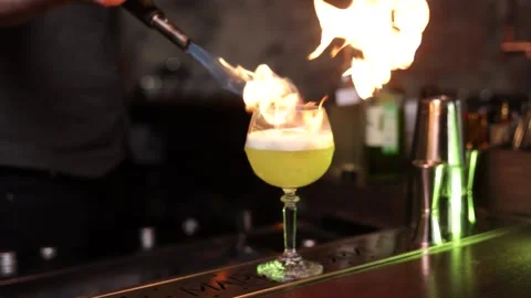 The bartender cook a drink with fire slow motion bar Stock Footage 168294866