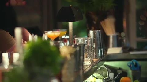 Bartender crafting a cocktail at an elegant bar, mixing drinks with style Stock Footage 337200719