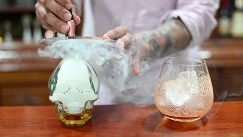 Bartender creating smoking skull cocktail Stock Footage 314132954