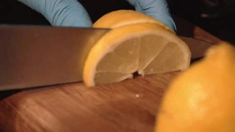 The bartender cuts a lemon for a cocktail Stock Footage 158021843