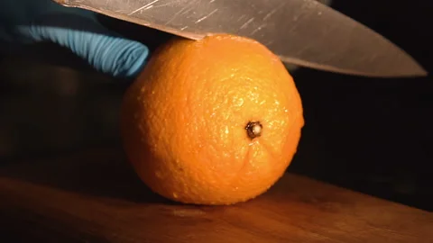 The bartender cuts an orange for a cocktail Stock Footage 158021821