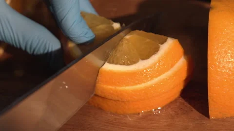 The bartender cuts an orange for a cocktail Stock Footage 158021826