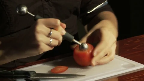 The bartender cuts a pile of vodka from a tomato. Stock Footage 80309647