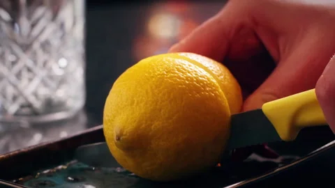 Bartender Cutting Fresh Lemon on Bar Counter in Close Up Stock Footage 328979299