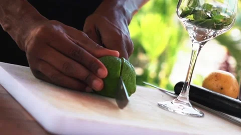 Bartender cutting lime and making passion fruit mojito cocktail, slow motion Stock Footage 230080310