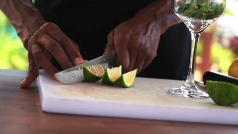 Bartender cutting lime and making passion fruit mojito cocktail, slow motion Stock Footage 230080314
