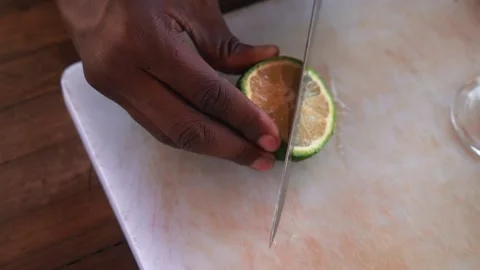 Bartender cutting lime and making passion fruit mojito cocktail, slow motion Video stock 230080372