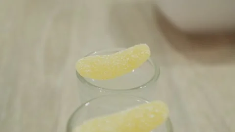 The bartender decorates the glasses with marmalade. One of them falls into a gla Stock Footage 134035332